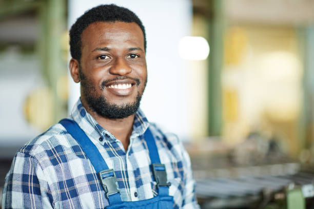 istock Smiling manual worker in factory shop 938887282