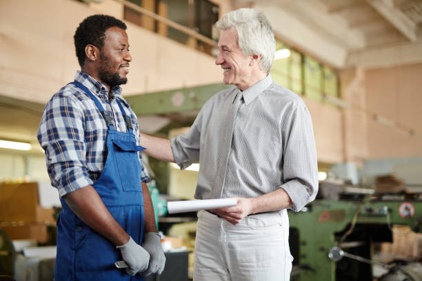 istock Quality control expert praising worker in plant 938887312