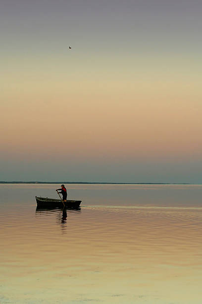 istock Lonely boat on silent water. sunset 93889306