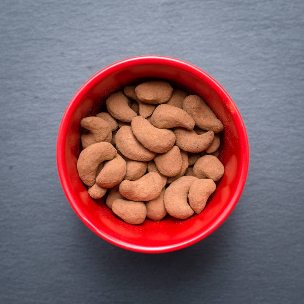Cashew nuts covered with cocoa powder, close up . Balinese dessert, Indonesia, island Bali