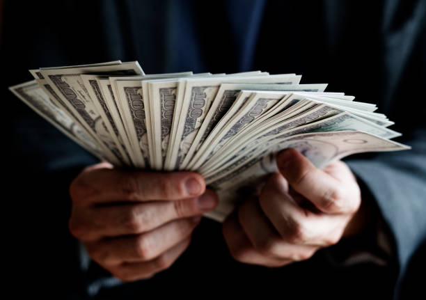 Closeup of hands holding cash stock photo