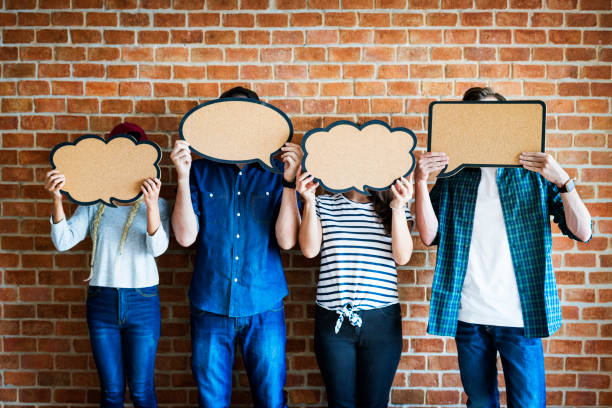istock Young adults holding up copy space placard thought bubbles 938915172