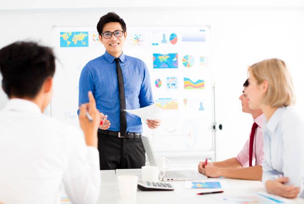 istock young Businessman presenting to colleagues at meeting 938915730