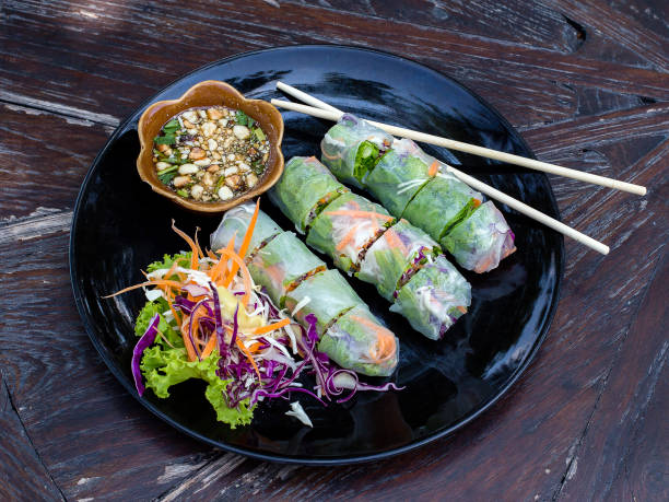istock Fresh vietnamese spring rolls on a plate with salad 938918500