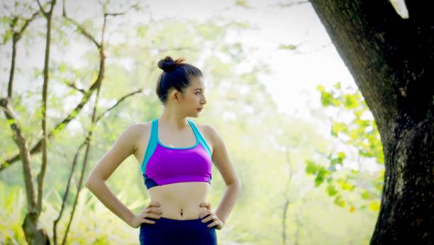 istock Young Woman Exercising At Park 938929980