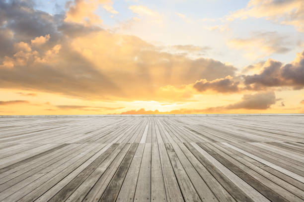 istock wood square floor and sky clouds at sunset 938938684