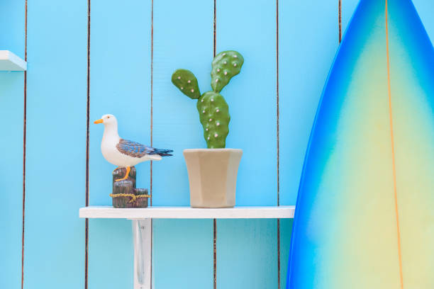 istock A seagull model and a cactus in a pot on the shelf with the surfboard. 938942014