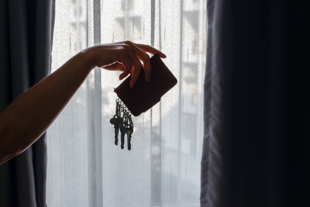 Asian female hand holding leather key holder with backlight stock photo