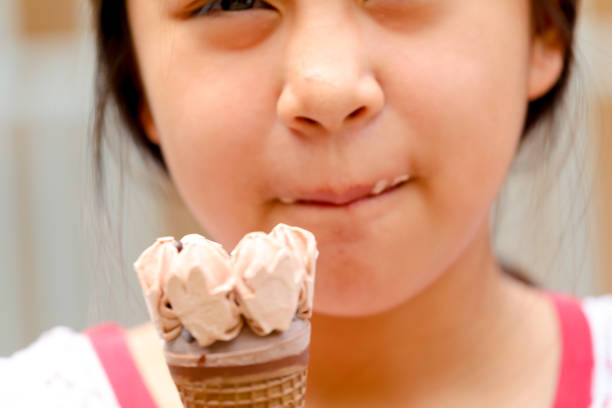 istock young girl eating ice cream 938950386