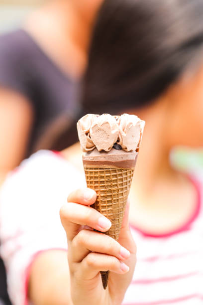 istock ice cream in young girl hand 938950914