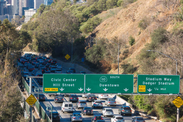istock Los Angeles skyline with freeway traffic and signs 938950960