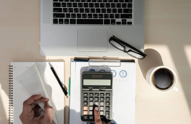 istock Close up businessman using calculator on documents Unrecognizable finance  use calculate about cost at office 938951300