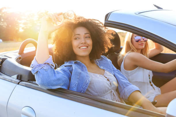 istock Girlfriends having fun on road trip 938955282