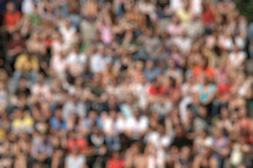 Blurred crowd of spectators on a stadium tribune at a sporting event