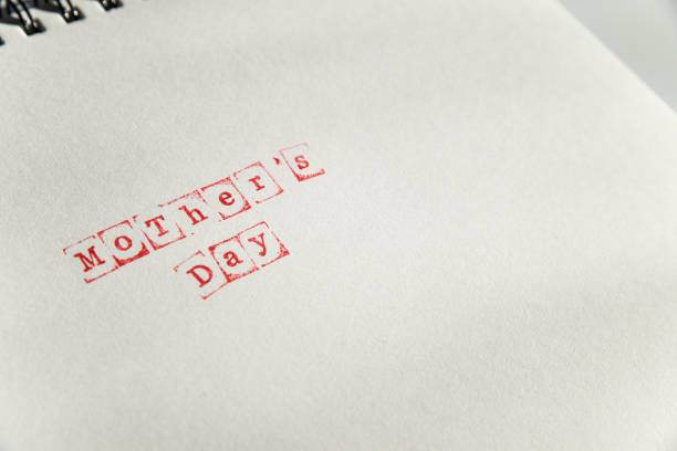 istock mothers day text on white sheet made via stamp 938958634