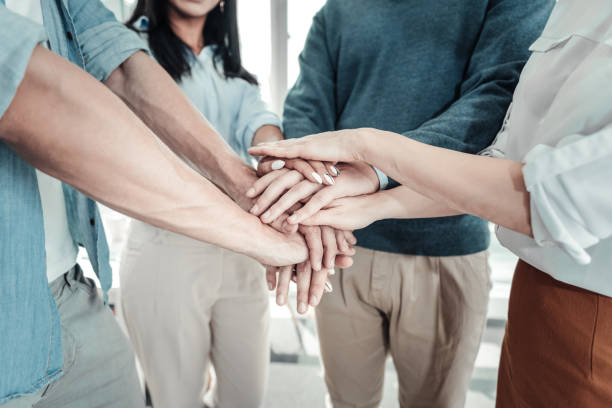 istock Reliable sociable colleagues gathering hand and communicating 938963932