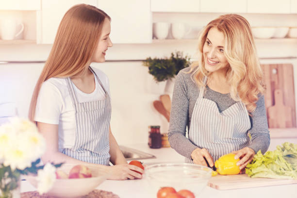 istock Positive delighted woman looking at her daughter 938975924
