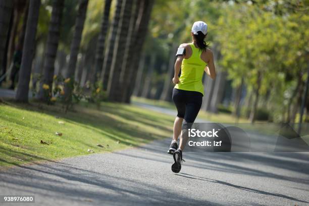 Sporty Young Fitness Woman Running At Tropical Park Stock Photo - Download Image Now