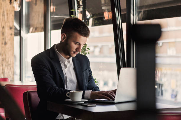 istock Businessman in cafe sending mails 938976766