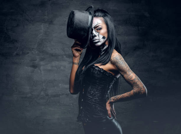 istock A girl in stylish top hat with skull make up. 938976814