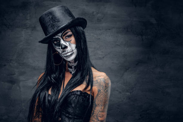 istock A woman with skull make up in top hat on Halloween. 938977000