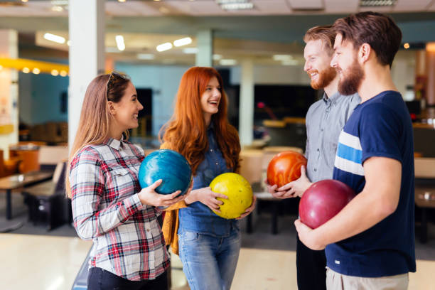 istock Cheerful friends bowling together 938977010