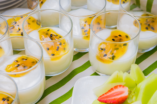 Passion fruit yogurt in clear glass at Spring Festival picnic event