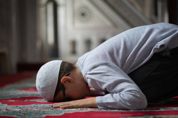 Muslim boy praying in Mosque