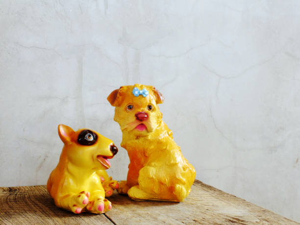 istock dog statue ceramic with space copy on wooden background 938977790