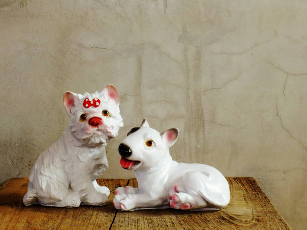 istock dog statue ceramic with space copy on wooden background 938978010