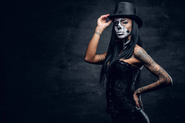 istock A girl in stylish top hat with skull make up. 938978222
