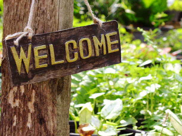 istock welcome sign hanging in the garden with space background 938981178