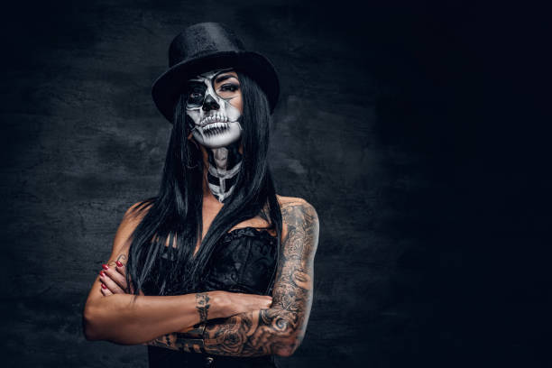 istock A girl in stylish top hat with skull make up. 938981474