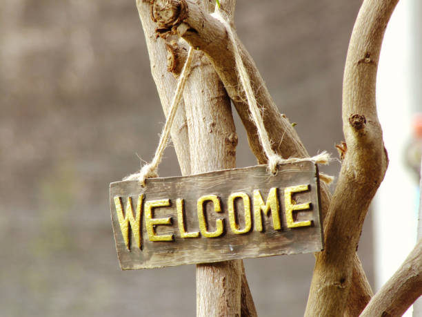 istock welcome sign hanging in the garden with space background 938982788