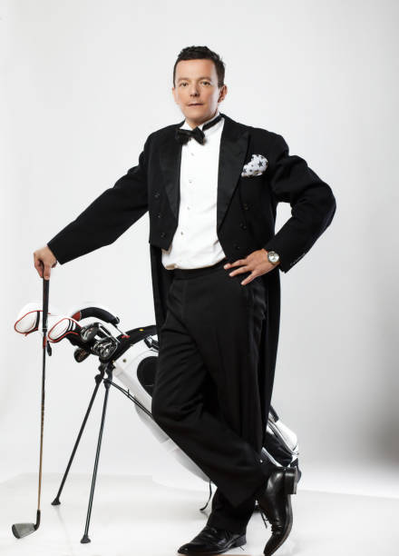 istock Happy man in dinner suit holds golf club. 938986368