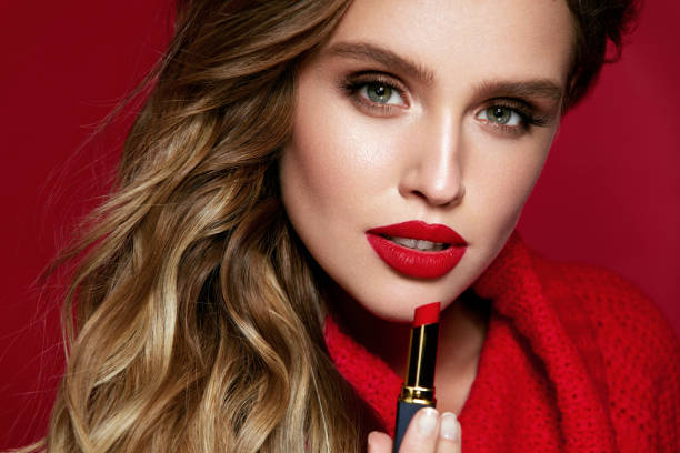 istock Red Lips. Beautiful Woman With Beauty Makeup Holding Lipstick. 938986488