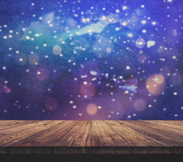 istock Wood table top with blurred light colourful bokeh abstract background 938987282