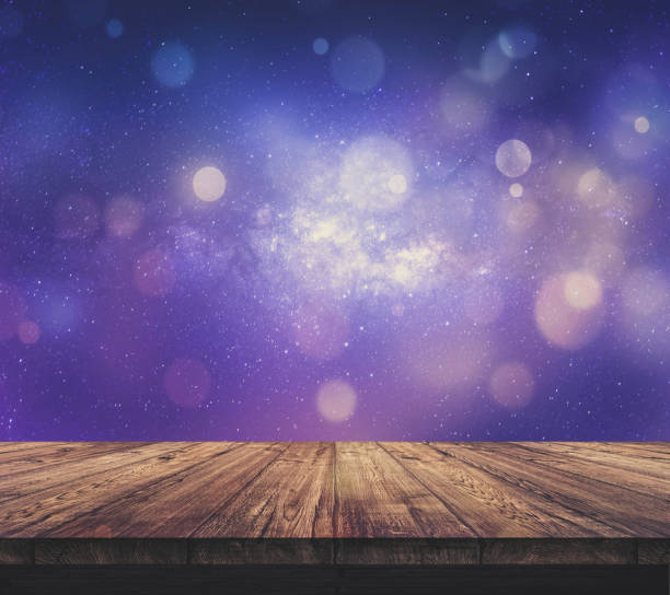 istock Wood table top with blurred light colourful bokeh abstract background 938989556