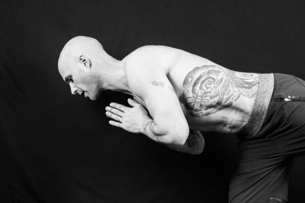 istock Muscular man meditates during yoga 938993268