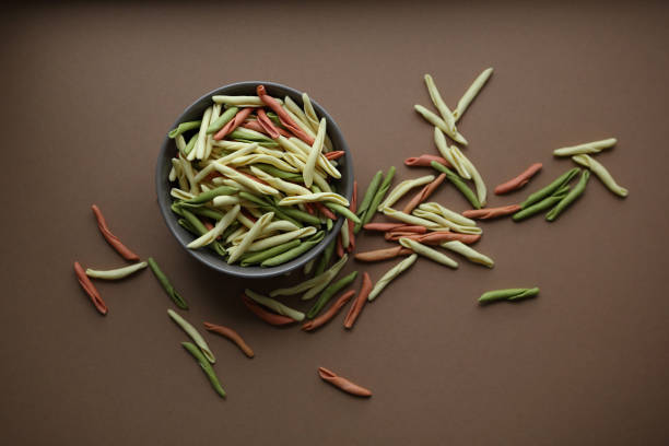 istock Raw pasta in bowl, food above 938993308