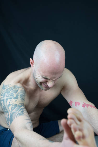 istock Muscular man meditates during yoga 938993564