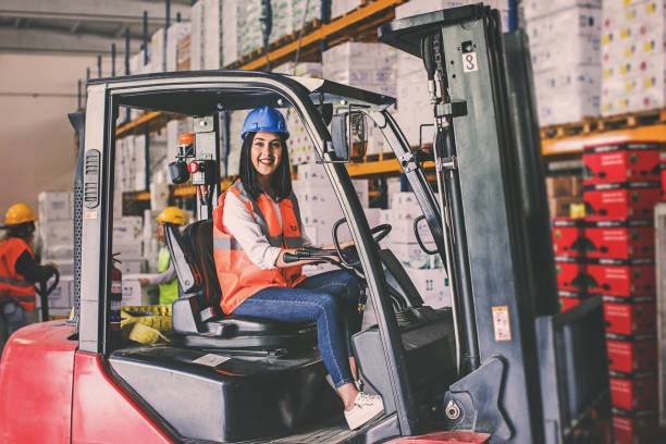 istock Young woman driving a forklift at warehouse 938993736