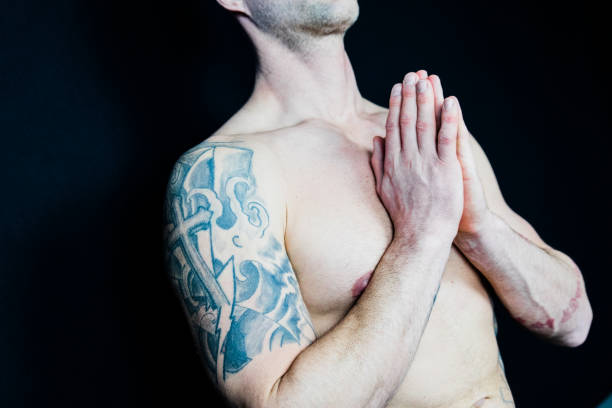 istock Muscular man meditates during yoga 938993946
