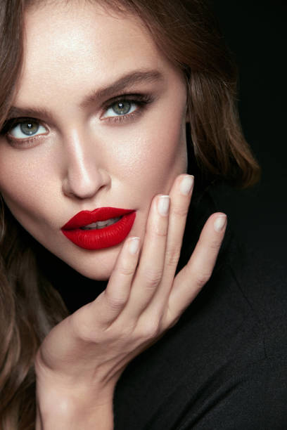 istock Beautiful Woman Face With Makeup And Red Lips. 938995802