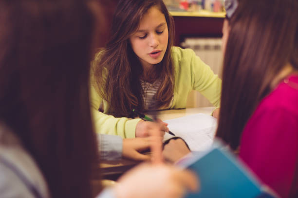 istock Schoolgirls working in group 938999238