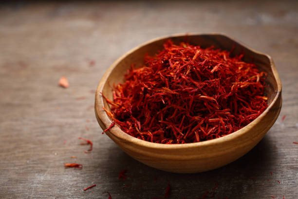 istock Red saffron in wood bowl 938999744