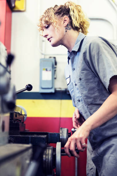 istock Female mechanic rotating the lever to ensure stability. 939004938