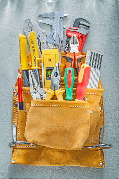 istock Assortment of construction tooling in tool belt on concrete back 939009028
