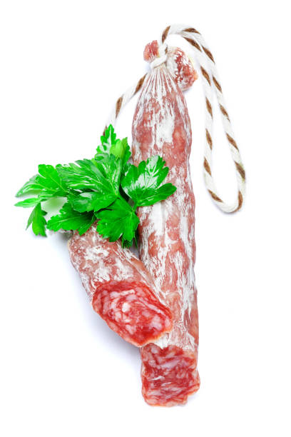 istock Dried sliced organic salami sausage on white background 939016572