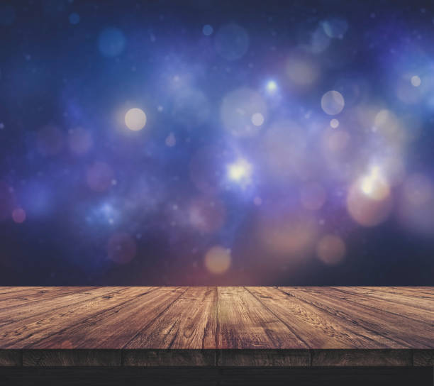 istock Wood table top with blurred light colourful bokeh abstract background 939017378